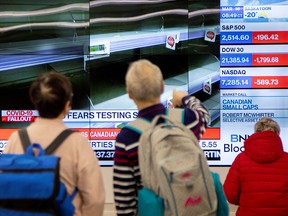 Monitors display the stock market numbers in Toronto's financial district as the number of novel coronavirus cases continues to grow in Canada on March 16, 2020.