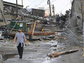 A man views damage in an alley behind Woodland Street after a tornado touched down in Nashville, Tennessee, U.S. March 3, 2020.
