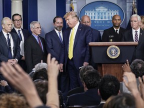 Surrounded by members of the White House Coronavirus Task Force, U.S. President Donald leaves the stage after speaking and taking no questions in the press briefing room of the White House March 9, 2020 in Washington, DC.