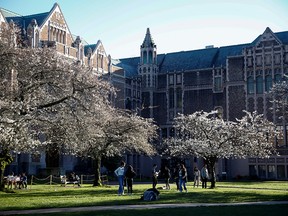 Students gather at the University of Washington, which has suspended in-person classes during the coronavirus outbreak, in Seattle, Wash., on March 16, 2020.