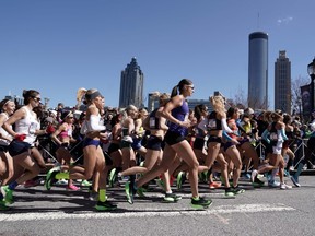 Feb 29, 2020; Atlanta, Georgia, USA; General overall view as women's runners run past the downtown skyline during the US Olympic Team Trials marathon.