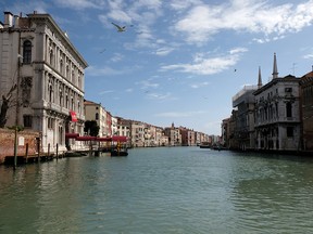 The Grand Canal in Venice is empty after Italy tightened the lockdown to combat COVID-19, on March 22, 2020.