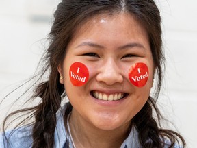 A voter with "I Voted" stickers smiles during the Democratic presidential primary in Minneapolis, Minnesota on Super Tuesday, March 3, 2020.