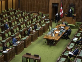 Prime Minister Justin Trudeau, Conservative Leader Andrew Scheer and other MPs wait for proceedings to begin in the House of Commons in Ottawa, as Parliament was recalled for the consideration of measures related to the COVID-19 pandemic, on April 11, 2020.