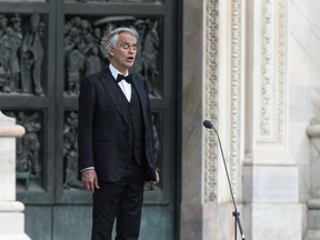 Italian tenor and opera singer Andrea Bocelli sings during a rehearsal on a deserted Piazza del Duomo in central Milan on April 12, 2020, prior to an evening performance without public for the world wounded by the pandemic, during the country's lockdown aimed at curbing the spread of the COVID-19 infection, caused by the novel coronavirus.