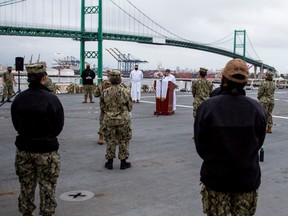 U.S. Navy sailors practice social distancing as they attend Sunday Easter sunrise service on the flight deck aboard the hospital ship USNS Mercy, serving as a referral hospital for non-coronavirus disease (COVID-19) patients currently admitted to shore-based hospitals, in Los Angeles, California, U.S. April 12, 2020.