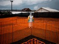 In this file photo taken on November 07, 2018 a health worker waits to handle a new unconfirmed Ebola patient at a newly build MSF (Doctors Without Borders) supported Ebola treatment centre (ETC) in Bunia, Democratic Republic of the Congo.