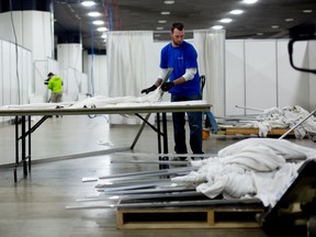 A contractor works at a field hospital under construction inside the TFC Center in Detroit, Michigan, U.S., on Saturday, April 4, 2020.