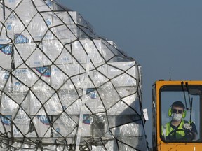 A batch of protective masks is unloaded from a Lufthansa airplane at the Franz-Josef-Strauss airport in Munich, southern Germany, having arrived from Shanghai.