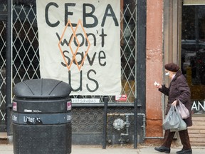 A closed store front boutique business called Francis Watson pleads for help displaying a sign in Toronto on Thursday, April 16, 2020.