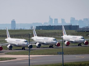 This file photo taken on March 24, 2020 shows grounded Air France airplanes at the Roissy-Charles de Gaulle airport in Roissy-en-France, north of Paris, on the eight day of a lockdown aimed at curbing the spread of the COVID-19 (novel coronavirus) in France.