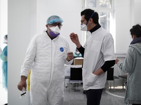 Staff members at a medical centre, wearing protective masks and gloves, work at a testing site for coronavirus disease (COVID-19) in Paris as the spread of the coronavirus disease continues in France March 30, 2020.