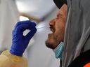 Provincial health workers perform coronavirus disease (COVID-19) nasal swab tests on Raymond Robins of the remote First Nation community of Gull Bay, Ontario, Canada April 27, 2020. 