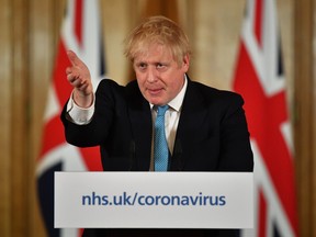 British Prime Minister Boris Johnson gestures as he speaks during a coronavirus news conference inside number 10 Downing Street on March 19, 2020 in London, England.