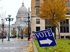 FILE PHOTO: A sign directs voters towards a polling place near the state capitol in Madison, Wisconsin, U.S.