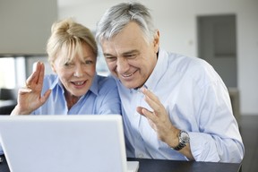 Senior cpouple saying hello to friends via internet