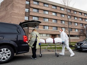 A body is transported on a stretcher after several residents died of the coronavirus disease (COVID-19) at the Eatonville Care Centre in Toronto, April 14, 2020.