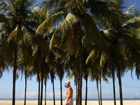 A man wears a protective face mask after Rio de Janeiro's mayor decreed using masks in public places following the coronavirus disease (COVID-19) outbreak, at Copacabana beach in Rio de Janeiro, Brazil, April 20, 2020.