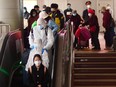 Passengers from Wuhan disembark in Beijing on Wednesday, April 15, 2020.