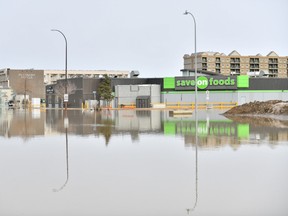 A grocery store is surrounded by flood water on Franklin Avenue in Fort McMurray, Alta. on Monday, April 27, 2020.