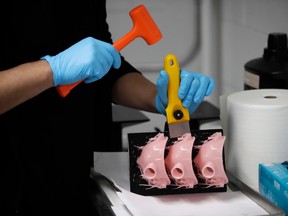 Ivan Zuleta, a manager for the 3D printing unit at Burbank Dental Lab, makes protective masks from a 3D printer Monday, April 6, 2020, in Burbank, Calif. Groups of volunteers across Canada are using 3D printers to produce personal protective equipment and other essential supplies at a breakneck speed — an effort some say could have a lasting impact even after the COVID-19 crisis passes.