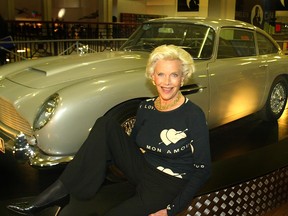 Actress Honor Blackman who played the part of Pussy Galore in the film "Goldfinger" poses for poses on an Aston Martin  DB5 car at the Bond, James Bond exhibition October 15, 2002 in London, United Kingdom.