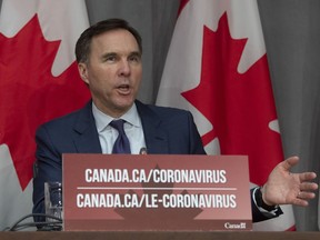 Minister of Finance Bill Morneau responds to a question during a news conference in Ottawa, Friday, March 27, 2020.