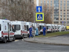Ambulances transporting people suspected of being infected with the COVID-19 coronavirus queue at Saint Petersburg's Pokrovskaya hospital on April 27, 2020.
