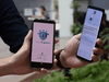 People demonstrate a contact-tracing smarthphone app used in Singapore called Trace Together, as a preventive measure against the COVID-19 coronavirus, March 20, 2020.