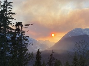Smoke from a wildfire hangs over the mountains in Squamish, B.C., Wednesday, April 15, 2020.