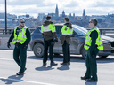 Quebec Provincial Police checking for drivers and passengers possibly infected with COVID-19 stop vehicles on the Macdonald-Cartier Interprovincial Bridge on Wednesday as they entered Gatineau from Ottawa.