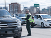 Quebec Provincial Police checking for drivers and passengers possibly infected with COVID-19 stop vehicles on the Macdonald-Cartier Interprovincial Bridge on Wednesday as they entered Gatineau from Ottawa.