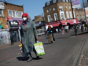 A  woman wearing a mask is seen in Dalston as the spread of the coronavirus disease (COVID-19) continues, London, Britain, April 14, 2020.