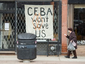 A closed store front boutique business called Francis Watson pleads for help displaying a sign in Toronto on Thursday, April 16, 2020.