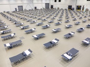 Beds are set up as a temporary homeless shelter at the Telus Convention Centre in Calgary on Wednesday, April 1, 2020 in this handout photo. Calgary Mayor Naheed Nenshi says it's not his first choice to make a downtown convention centre into a temporary homeless shelter during the COVID-19 pandemic. But he says organizers have done an extraordinary job setting it up and taken thoughtful steps to ensure physical distancing is being encouraged among those staying there.