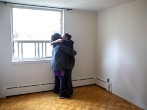 Nikki and Romeo share a moment after moving from a tent to a temporary apartment in Toronto, provided by the city, on Thursday, April 30, 2020. The City of Toronto says it is moving some people living in tents into apartment buildings as part of its effort to curb the spread of COVID-19 in the city's homeless population.