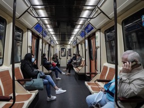 Commuters maintain social distancing while riding the Madrid Metro in Madrid, Spain, on Monday, April 13, 2020. Italy, Spain and France reported a slowdown in new coronavirus cases, allowing governments in Europe to look for ways to safely ease lockdowns that are strangling the region’s economy.