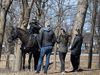 Police on horseback approach people in a Montreal park amid the COVID-19 crackdown.
