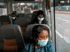 A medical worker wearing a protective mask rides a free shuttle service for healthcare workers in Manila. Philippine President Rodrigo Duterte has ordered police to protect health workers after reports of assaults.