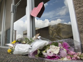 Flowers are seen at the front door of Dr. Denis Vincent's dental practice in North Vancouver, B.C. Tuesday, March 31, 2020. Dr. Denis Vincent is being remembered as a dedicated dentist who made patient care and safety his top priority. Vincent was 64 when he died on March 22 after attending the Pacific Dental Conference, which drew about 15,000 people.