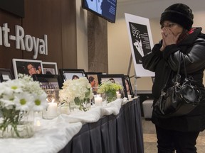 A woman pauses at a makeshift memorial prior to a ceremony in Montreal, Sunday, Jan. 19, 2020, to remember those who lost their lives in Ukraine International Airlines Flight 752 which was shot down shortly after takeoff in Iran on January 8, 2020. The investigation into Iran's downing of a commercial jetliner that killed dozens of Canadians in January has hit a snag due to COVID-19.