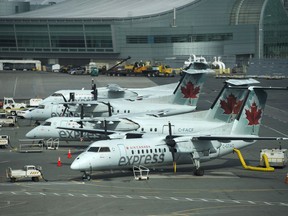 Air Canada planes sit on the tarmac at Pearson International Airport in Toronto on Wednesday, April 8, 2020. Commercial airlines across Canada have announced in recent weeks that they are temporarily laying off pilots and other staff as the industry struggles with plummeting demand due to the COVID-19 pandemic.