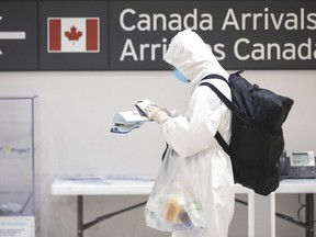 A traveller stands in the International arrivals hall at Toronto's Pearson Airport, on Friday, March 27, 2020. Six planes carrying Canadians stranded in Africa and Europe are to touch down today in the government's effort to repatriate travellers stranded by COVID-19.