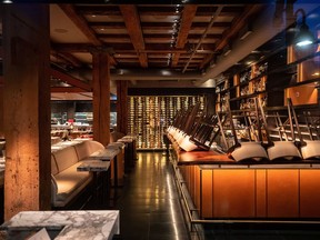 Chairs are turned upside down on the bar at a closed restaurant, amid concerns about the spread of the coronavirus, in Vancouver, on Tuesday, March 17, 2020. COVID-devastated bars and lounges as well as the country's hard-hit cannabis sector will have access to $40 billion in new credit being made available via the government's business bank, its CEO said on Sunday.