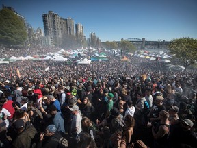 Smoke hangs over the crowd as people smoke at 4:20 p.m. during the annual 4-20 marijuana celebration in Vancouver on Saturday, April 20, 2019.