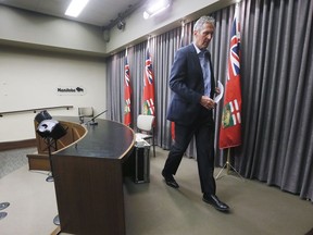 Manitoba Premier Brian Pallister, right, leaves a COVID-19 press conference at the Manitoba legislature in Winnipeg Thursday, March 26, 2020. The Manitoba government is postponing public events marking the province's 150th birthday due to the COVID-19 pandemic.