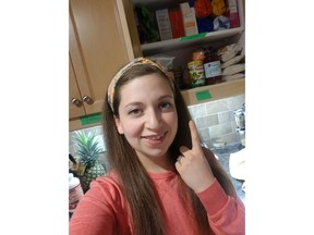 Michelle Devorah Kahn, 30, stands in her Ottawa kitchen, in this handout image, as she shows off her shelves organized and ready for the Jewish holiday of Passover, which begins April 8 at sundown. Usually, Kahn travels to celebrate the holiday with her family but COVID-19 means this year, she's staying home.