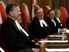 Supreme Court Justice Peter Cory (left) shares a laugh with other justices Claire L'Heureux-Dube, Chief Justice Antonio Lamer Charles Gonthier and Beverley McLachlin (left to right) during a ceremony marking his retirement from the Supreme Court, in Ottawa Friday May 14, 1999. Former Supreme Court of Canada justice Peter Cory has died.