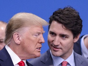 Prime Minister Justin Trudeau and U.S. President Donald Trump arrive to take part in a plenary session at the NATO Summit in Watford, Hertfordshire, England, on Wednesday, Dec. 4, 2019. Donald Trump's envoy to Canada is defending the U.S. president's controversial decision to temporarily stop funding the United Nations World Health Organization during the COVID-19 pandemic.