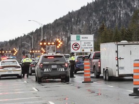 Police forces check on motorists as highway 175 is closed, Sunday, March 29, 2020 north of Quebec City.